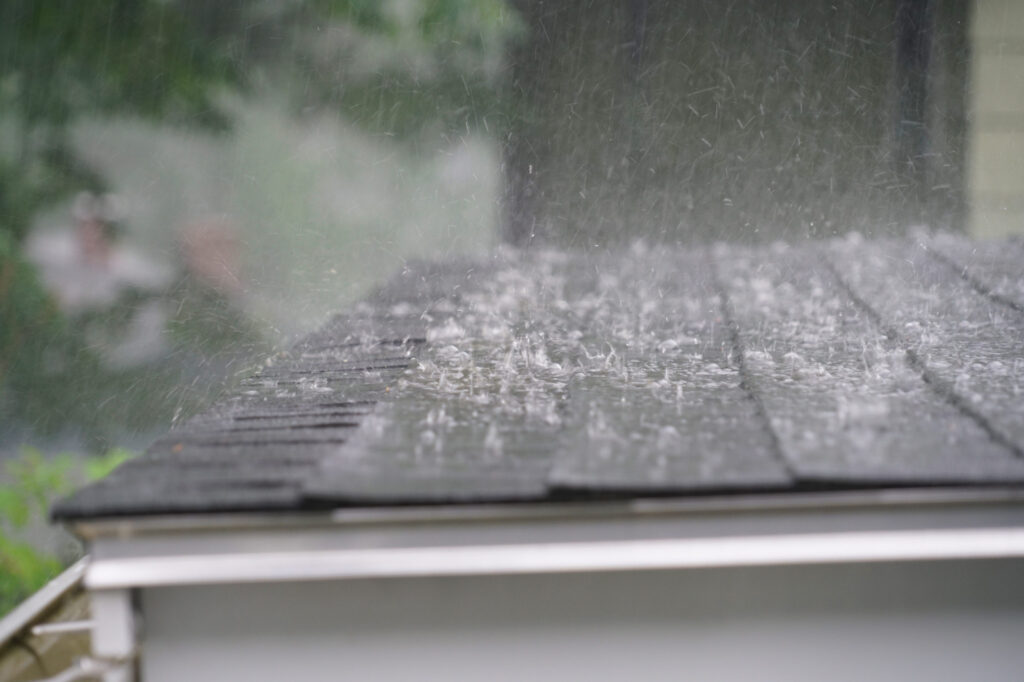 close-up of heavy rain splashing onto a flat roof