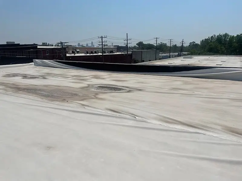 A flat, commercial roof that needs replacement