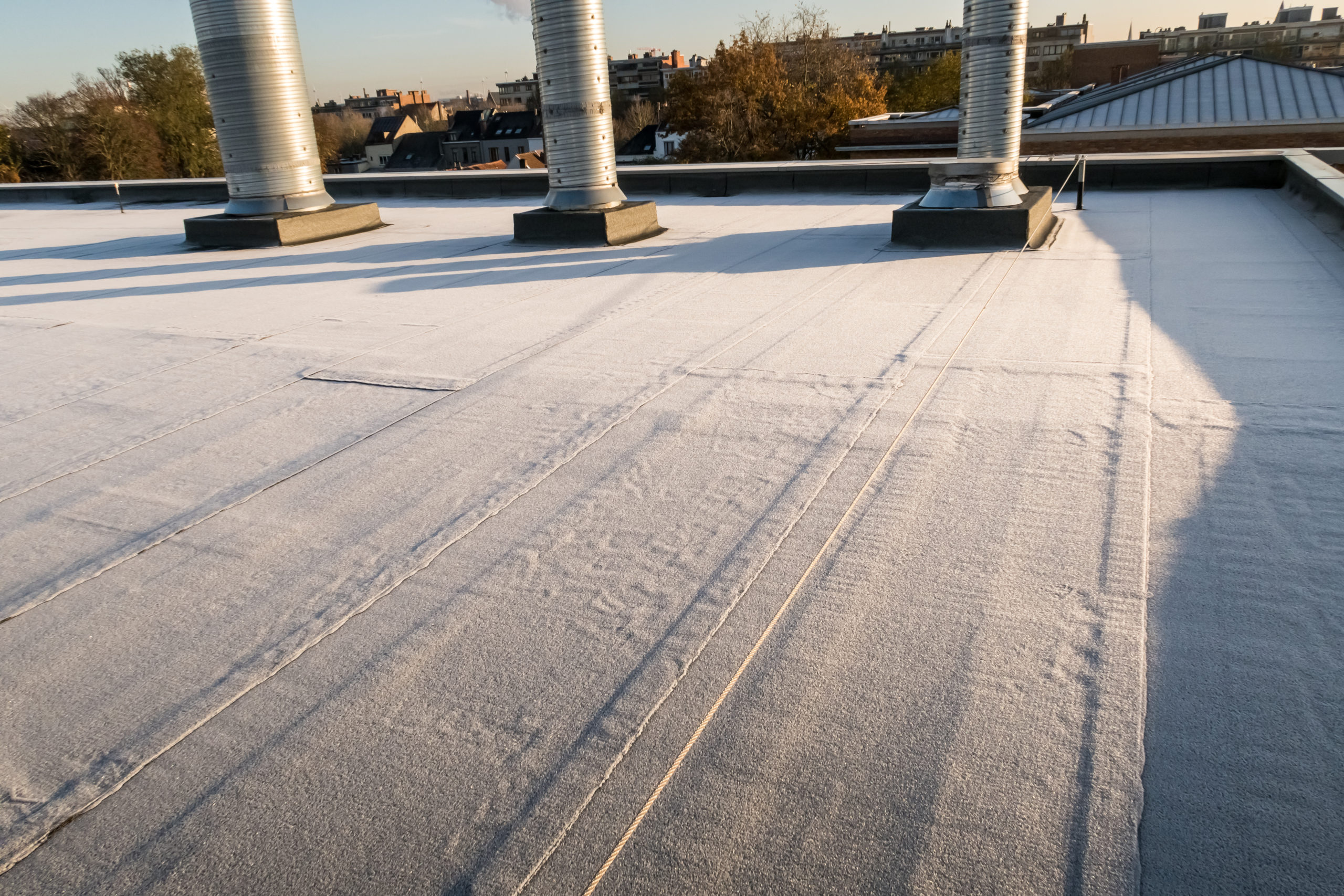 a commercial flat roof covered in packed snow
