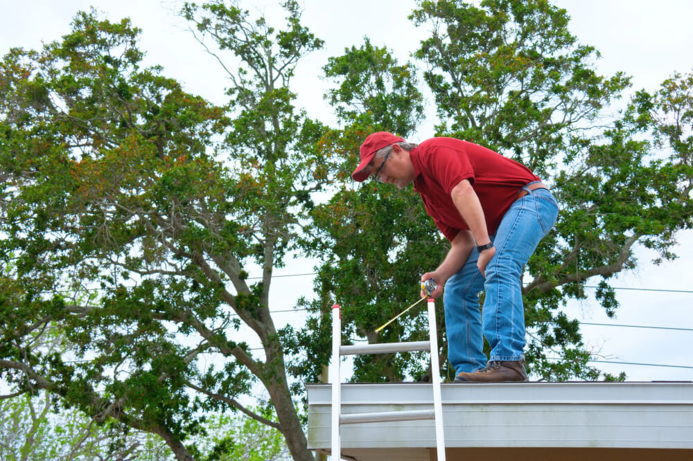 Wind mitigation inspection inspector wearing safety goggles doing inspection on new roof