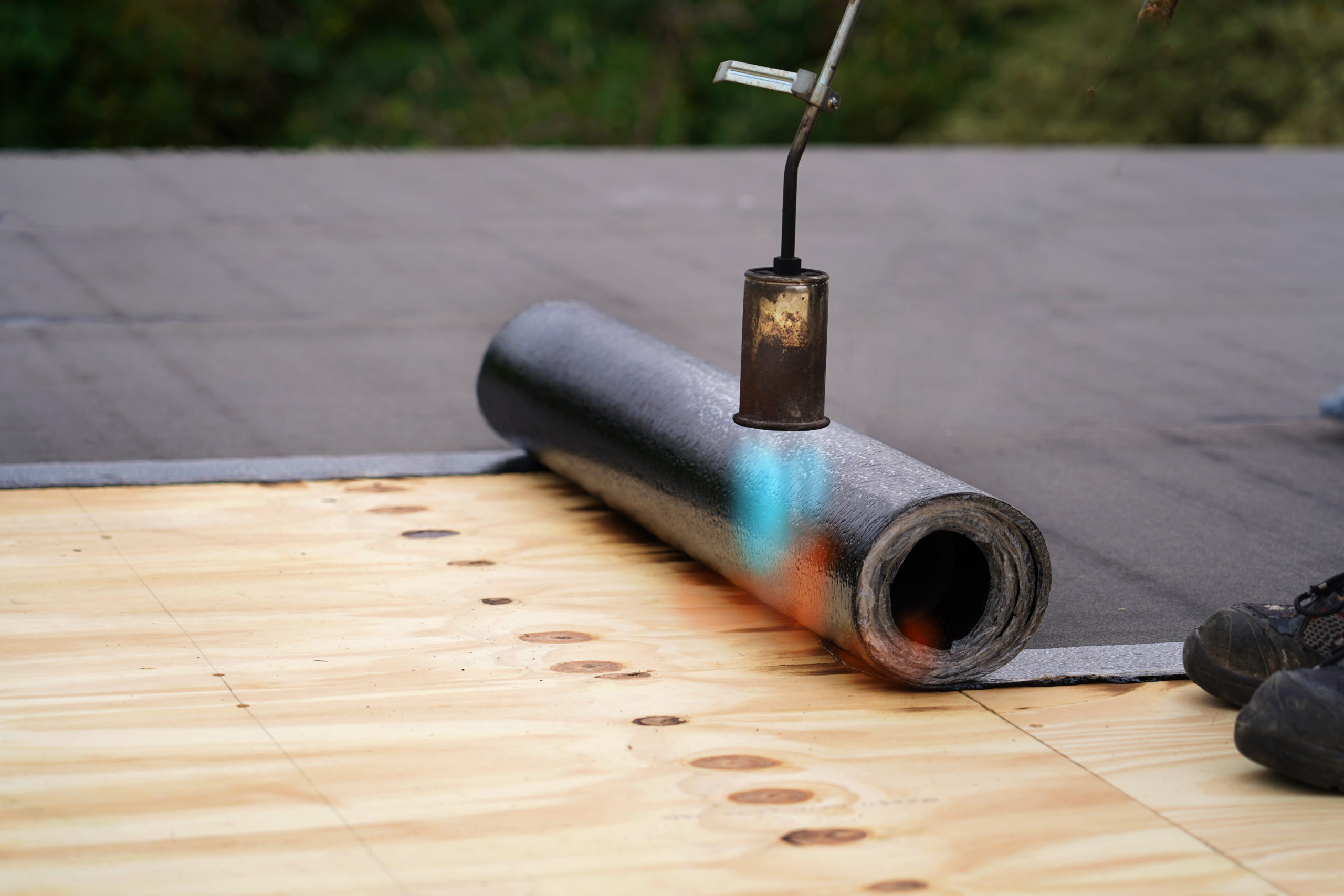 Bitumen roofing with a roll of tar paper