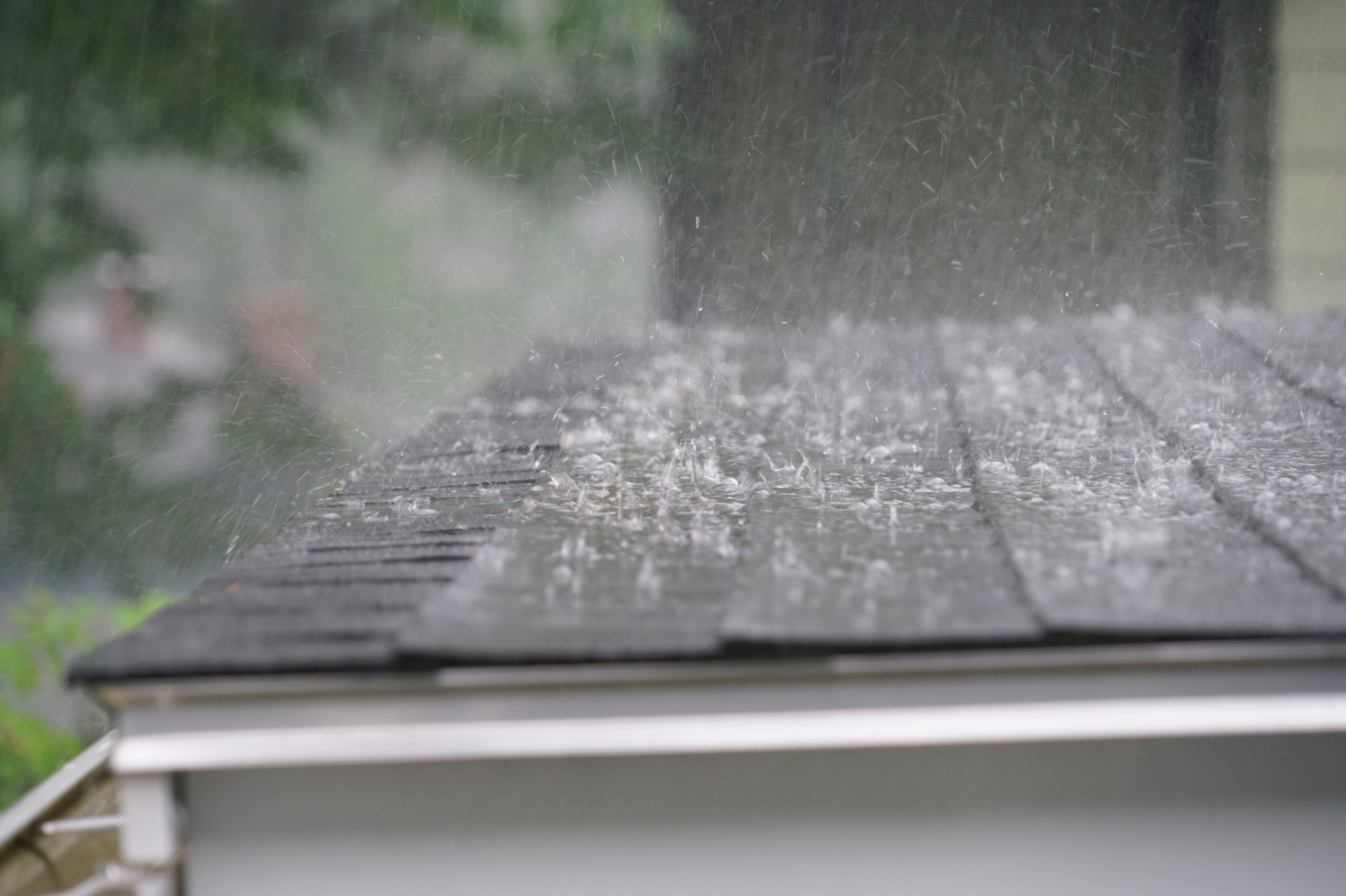 close-up of heavy rain splashing onto a flat roof