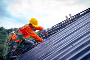 Commercial roof installation done by a construction worker