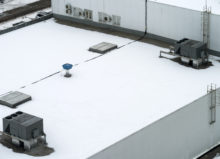 Commercial flat roof covered in snow