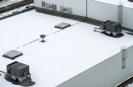 Commercial flat roof covered in snow