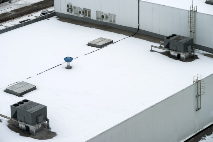 Commercial flat roof covered in snow
