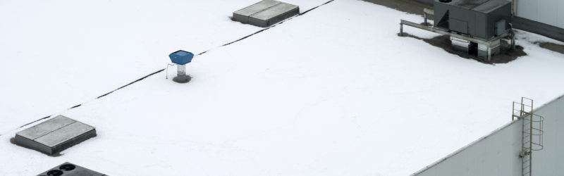 Commercial flat roof covered in snow