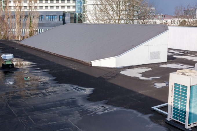 Large commercial roof with water pooling