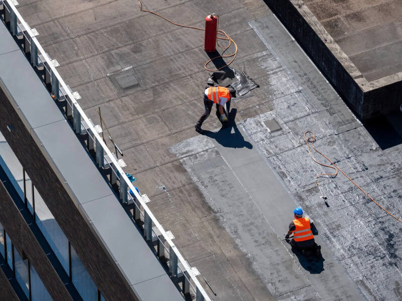 Workers Re-Roofing a Warehouse Roof